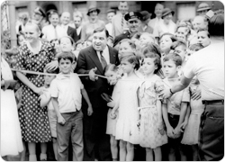 Mayor Fiorello LaGuardia cuts the ribbon, thus opening Dr. Gertrude B. Kelly Playground to the public, August 8, 1934.