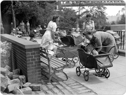 August 6, 1943 shot of mothers, strollers, and babies in the park.