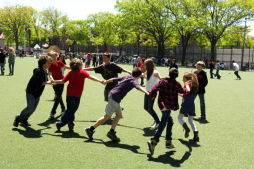 Children Playing at J.J. Byrne Playground's Synthetic Turf Field
