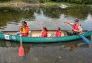 An Urban Park Ranger leads a canoe of children