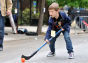 A boy playing street hockey