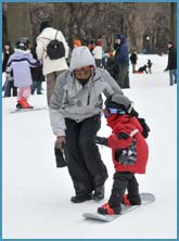 Child learning how to snowboard