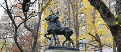 statue of Joan of Arc with a sword in hand while riding a horse