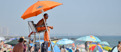 a lifeguard looks out on the beach