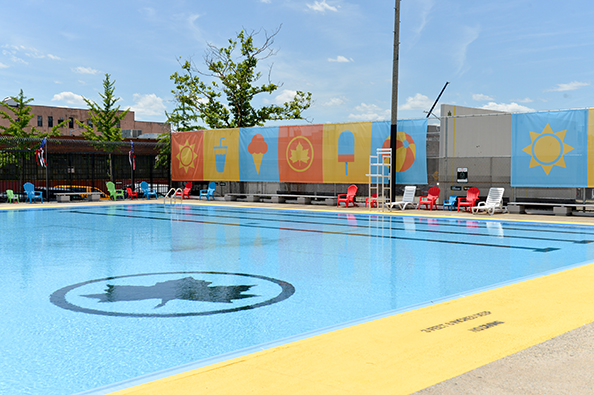 On Douglas and DeGraw’s pool wall is a banner decorated with summer-themed art: a sun, water bottle, ice cream cone, park leaf, popsicle, and beach ball.