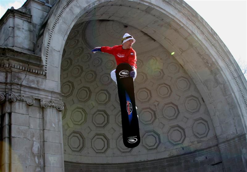 A performer shows the audience a trampoline jump using a ski board.