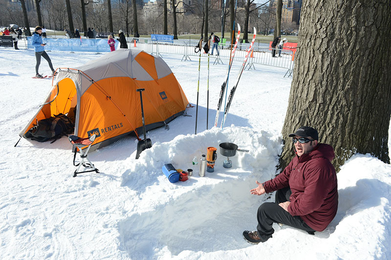 A man demonstrates camping gear and wilderness survival tips.