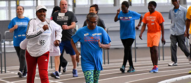 Seniors run around a track