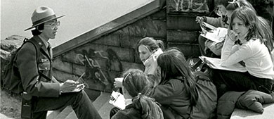 an Urban Park Ranger leads a kids program on the steps of a castle