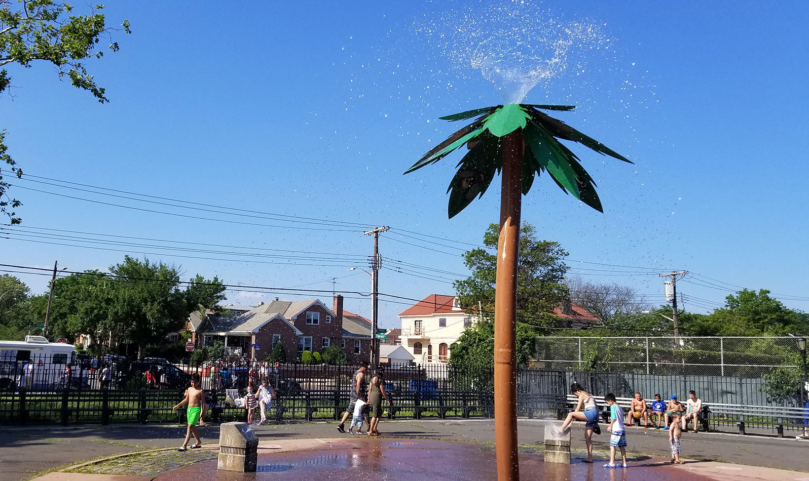 While playing under the hot summer sun, kids can cool down under this palm tree spray shower in Pat Parlato Playground.