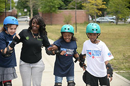 Kids roller skate with a Parks staff memmber