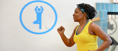 a woman performs aerobic exercises indoors