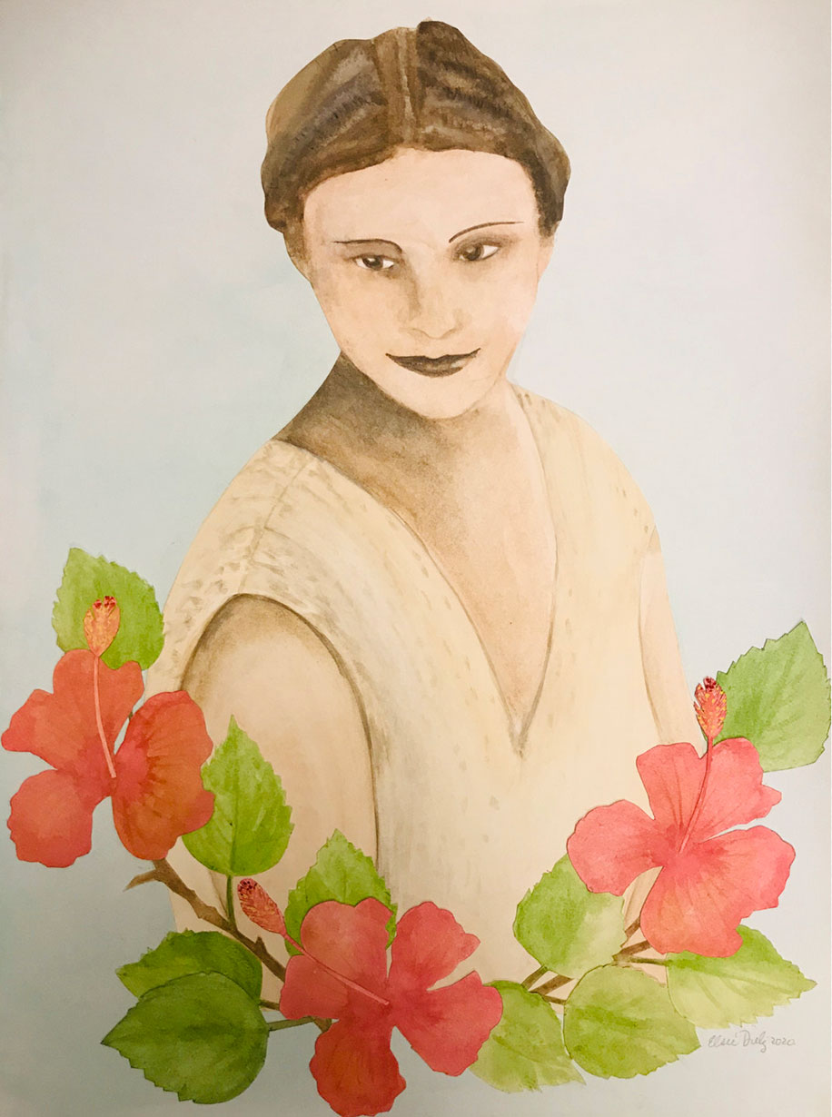 Portrait of a woman sitting behind a bunch of red hibiscus flowers as she looks downward smiling