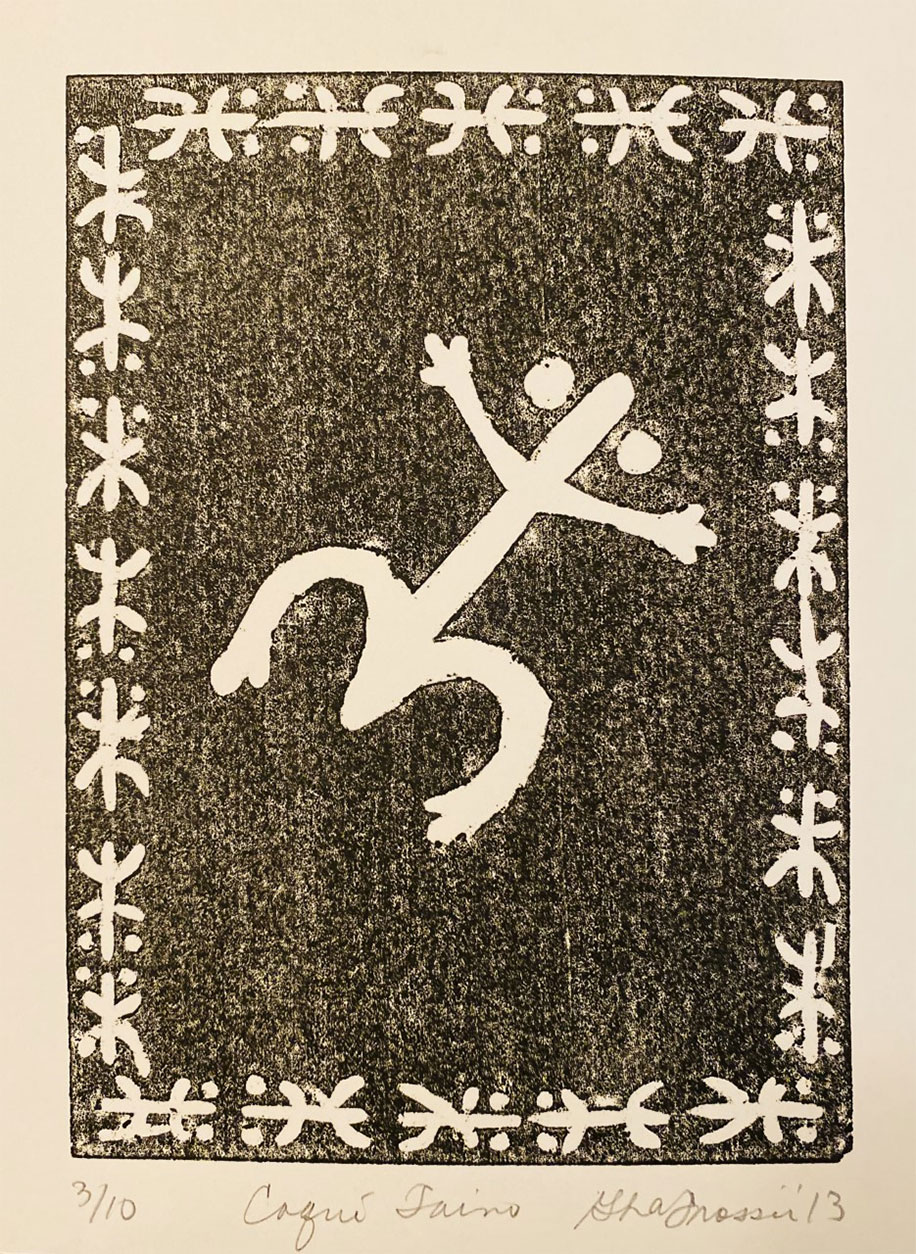 Black and white woodwork image of a coqui at the the center of the piece. The artwork is bordered by several carved out drawings of the coqui