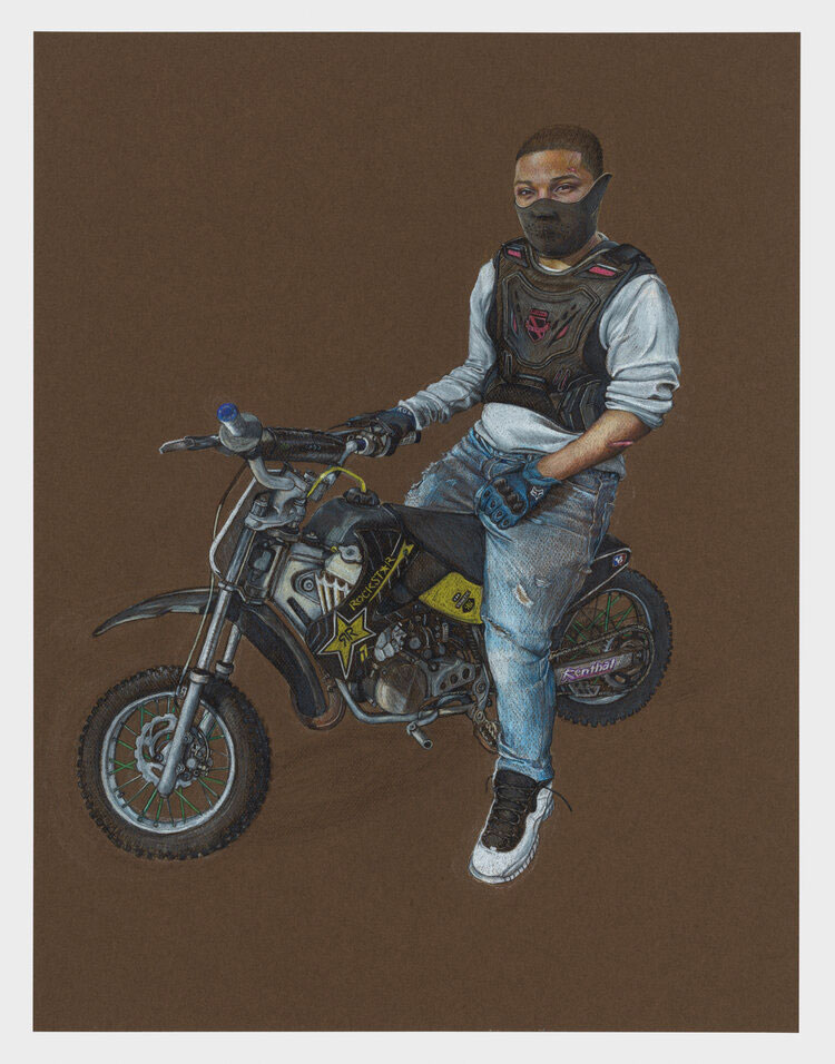 A Black biker with a black mask on sits on a bike