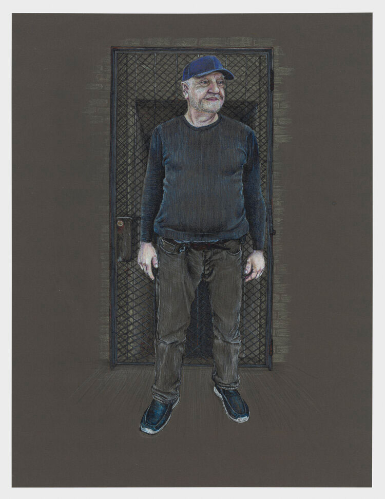 A man with gray hair and a blue cap looks out from the doorway