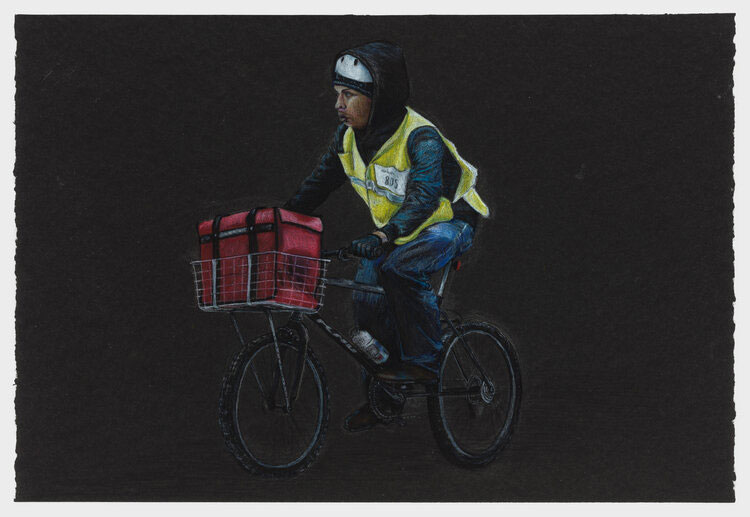 A delivery worker wears a yellow vest while riding between delivering food