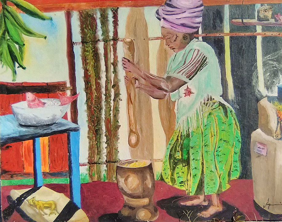 A woman with her hair wrapped up and barefoot uses a large wooden ladle to stir the food over a fire. There is fish on a table on the side under where a bunch of green bananas are placed