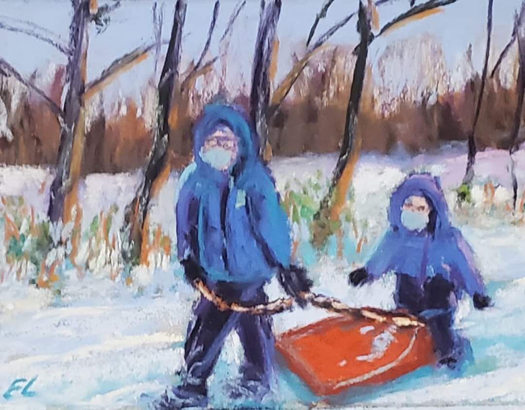 An adult and kid pull a sled through the snow covered park