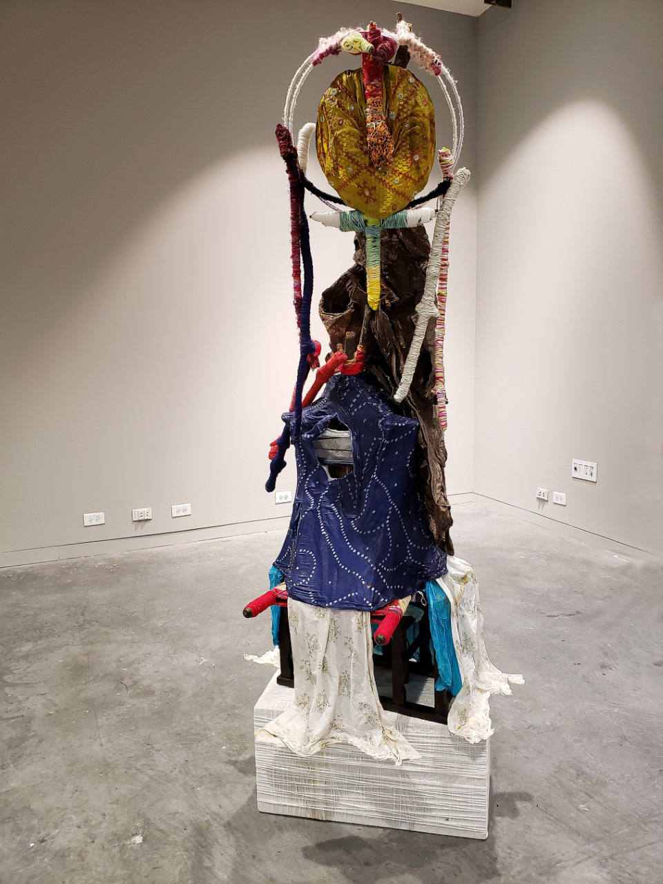 a sculpture of fabric and thread wrapped around objects to form the image of the god Ek Chuah