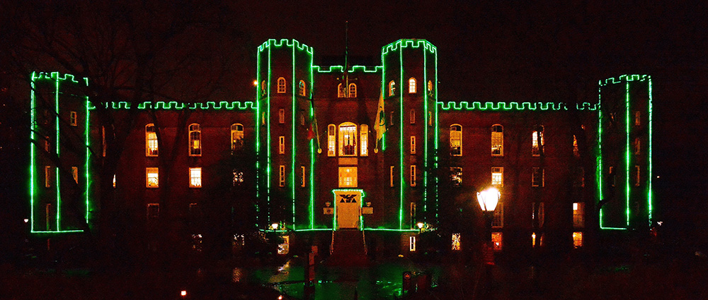 green holiday lights outline the Arsenal, a castle like building in Central Park, which is the headquarters of NYC Parks