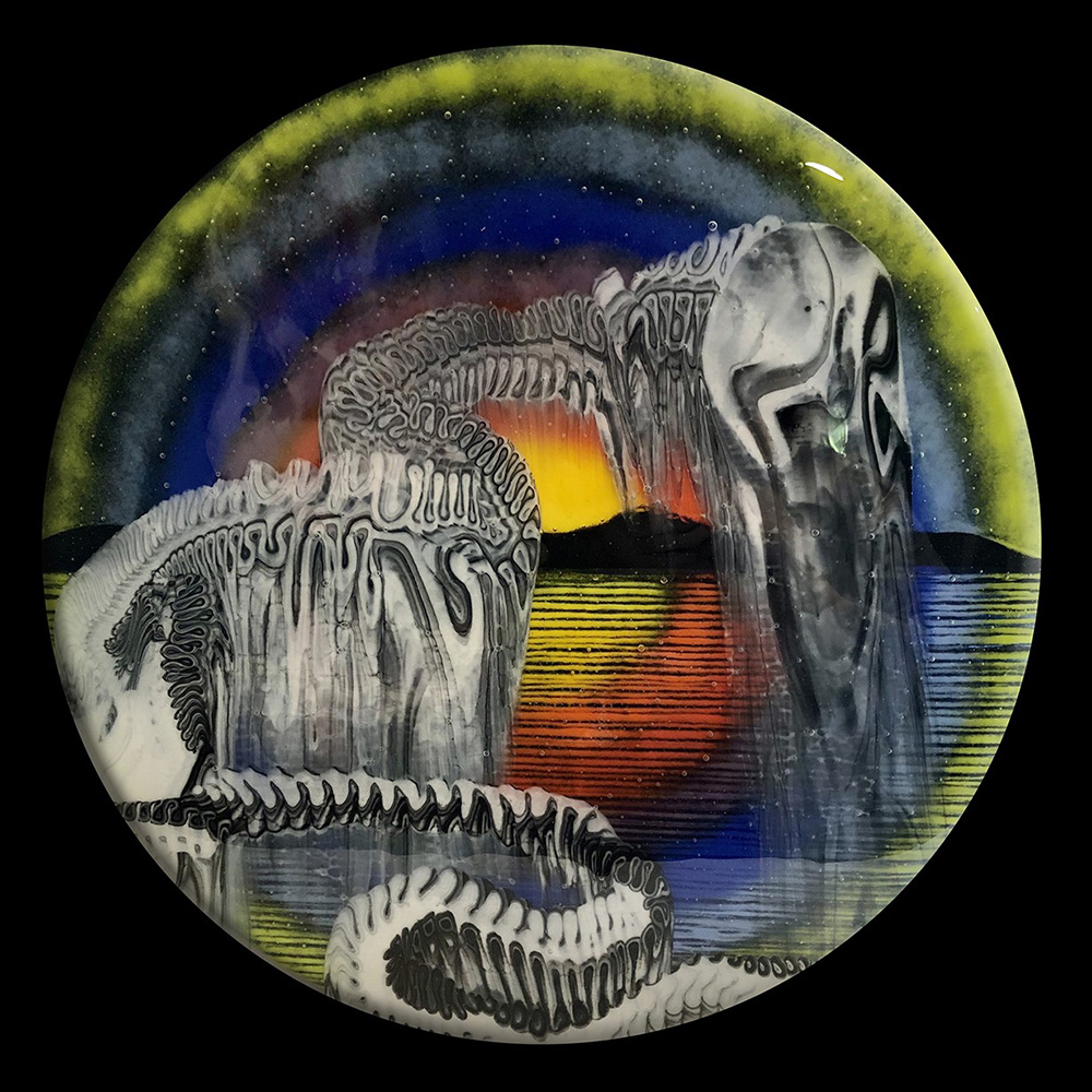 on the plate is a skeletal like image of a creature against the backdrop of a sun setting on a landscape