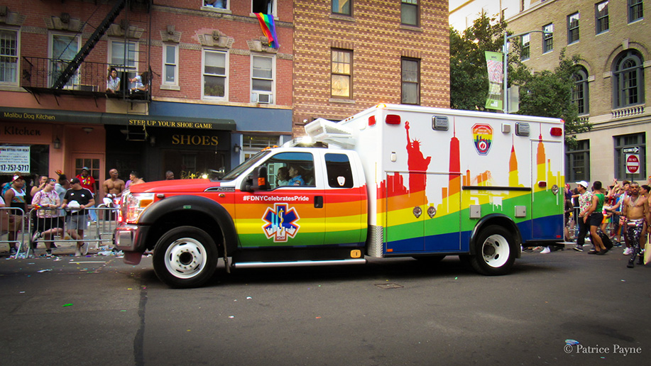 At a parade, an FDNY truck is painted in Pride colors