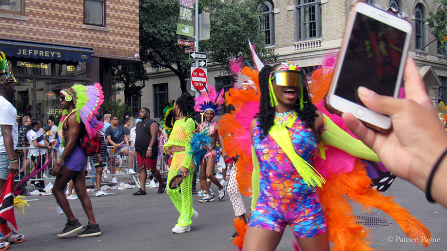 a parade guest records the parade on their phone