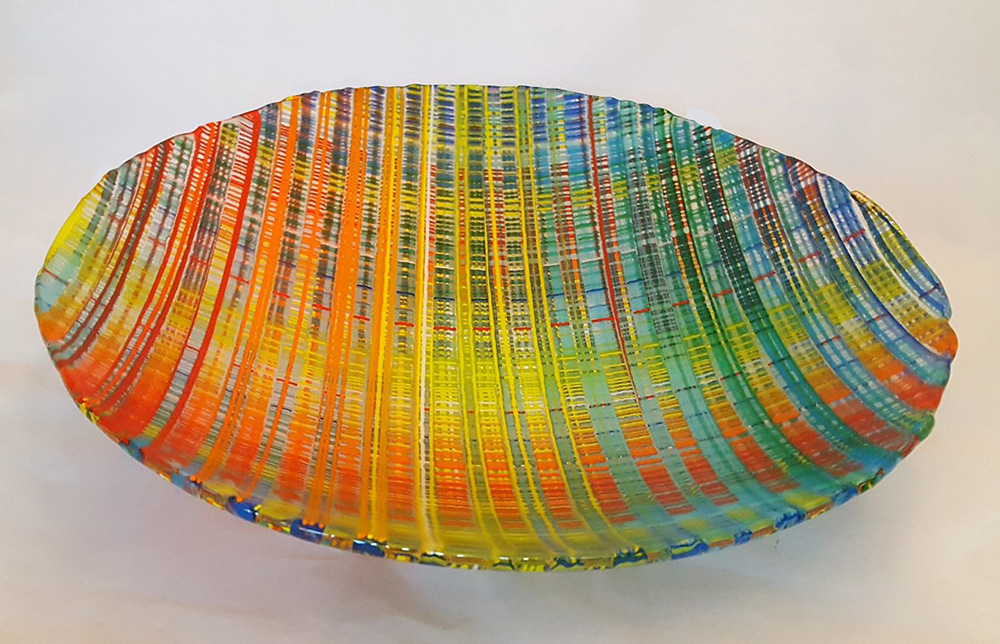 shades of orange, green, yellow, and blue like a weaving on the plate