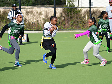 Girls playing flag football.