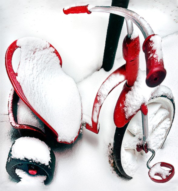 a tiny red tricycle covered in snow