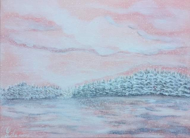 pink sky above a forest covered in snow and reflecting on a lake