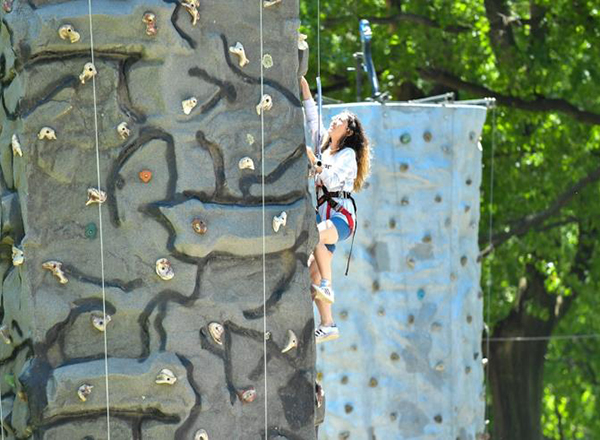 A girl climbing a rock wall