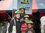 Group of people posing with bike helmets on