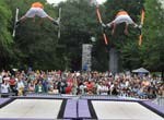 Two people performing trampoline acrobatics