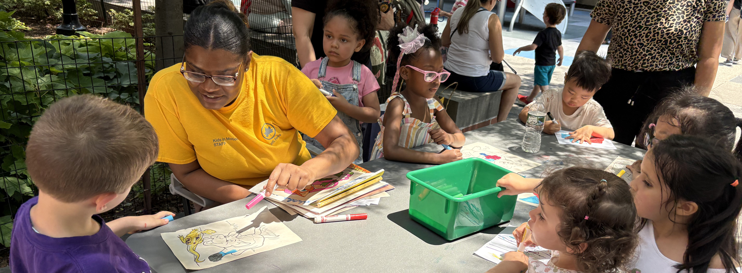 A group of kids at a craft table with an instructor