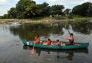 A ranger and children begin a ride around the lake