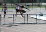 Hurdling at the PSAL season opening meet